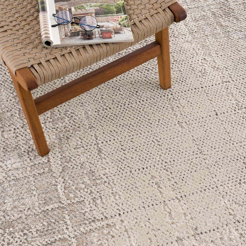 Close-up of the Colson Sage Area Rug showing its ash, pale pink, and sage colors and contemporary design. Styleshot