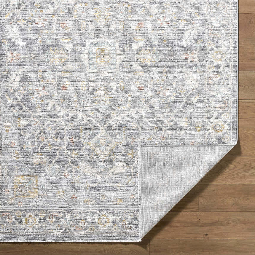 Close-up of the Xiye Silver Medallion Rug showing the traditional pattern, colors, texture, and machine-woven construction. Fold