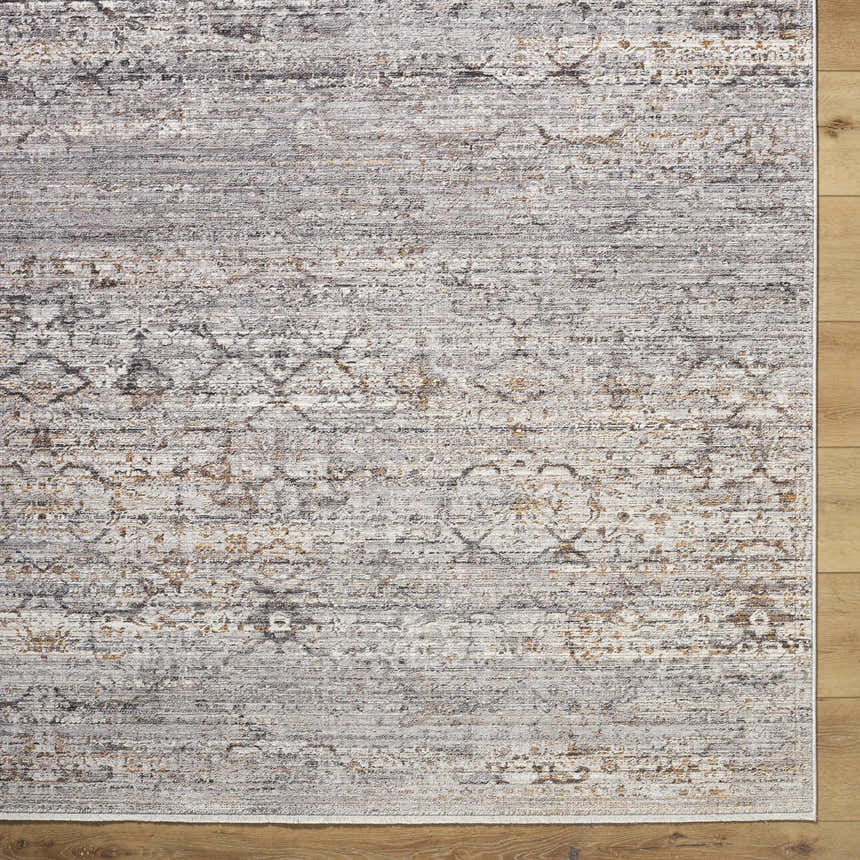 Close-up of the Cemile Area Rug. Machine-woven polyester rug in black, gray, ivory, brown, and taupe. Traditional farmhouse style. Swatch