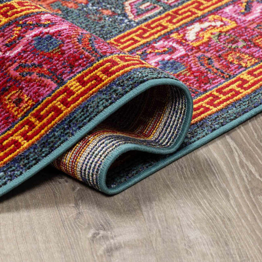 Close up of the Cleveland Colorful Traditional Area Rug, teal, aqua, navy, with a vintage-inspired pattern. Fold