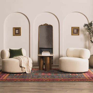 Living room scene with the Cleveland Colorful Traditional Area Rug in teal, aqua, and navy, paired with cream chairs and arched decor. Roomscene-Rectangle