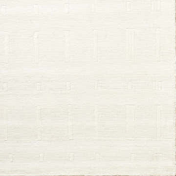 Close-up of a hand-tufted Charan Ivory Cream area rug with a raised, geometric pattern and textured wool. Corner