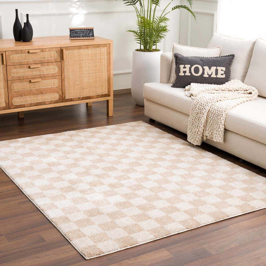 Living room scene with Canika Checkered Cream Washable Area Rug, beige sofa, wood cabinet, and potted plant. Roomscene-Rectangle