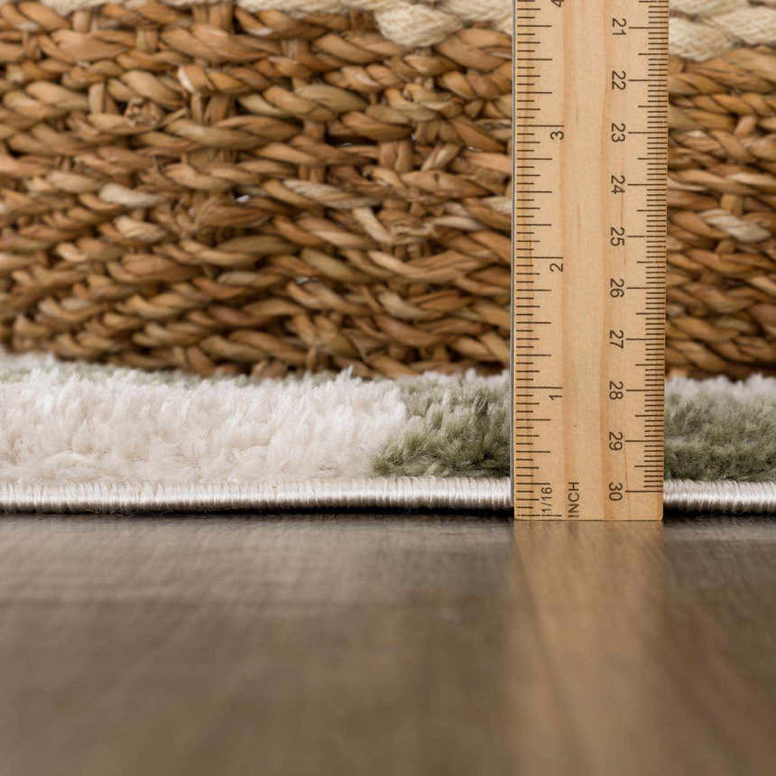 Close-up of the plush texture and pile height of the Canika Green Checkered Washable Rug. Pile