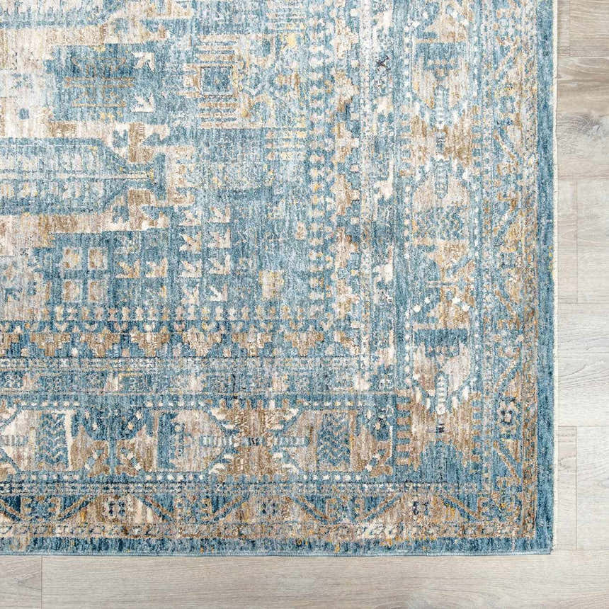 Close-up of the Mirabel Denim Blue Traditional Rug. Features a detailed oriental pattern in denim, cream, and brown hues. Swatch