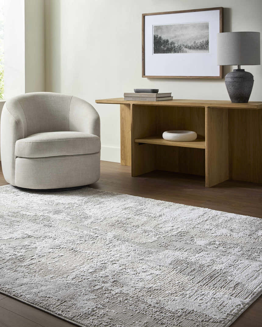 Living room scene with cream chair and Chroma Abstract Cream Area Rug. Neutral color palette. Roomscene-Rectangle