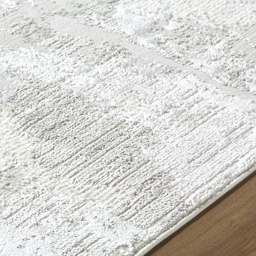 Close-up of the cream Chroma Abstract Area Rug showing its soft texture and subtle ivory and gray contemporary pattern. Texture