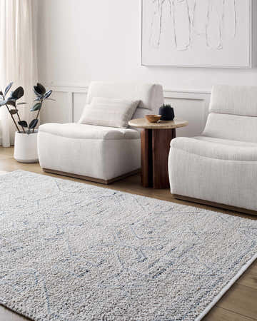 Living room scene with a contemporary Arctic Sky Cosmin Area Rug, beige chairs, and neutral decor. Roomscene-Rectangle