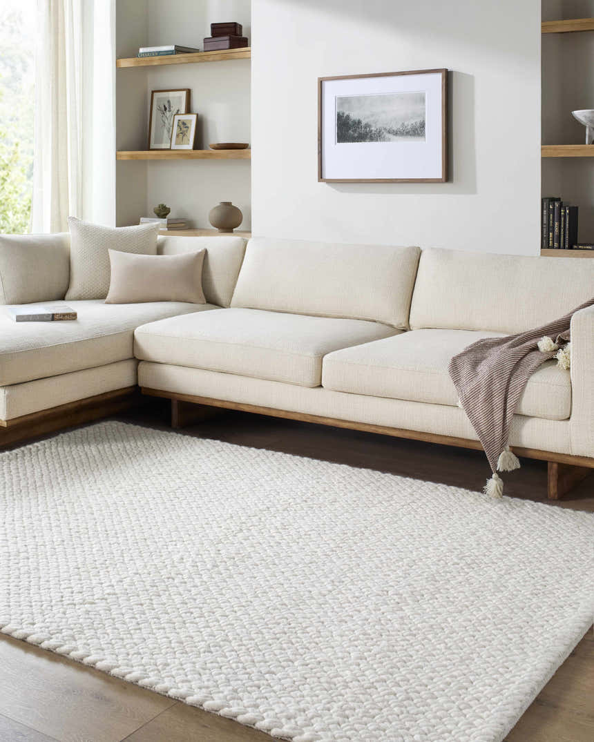 Living room scene with a cream sectional sofa and a Cqasce Navy Solid Hand Woven Wool Area Rug. Roomscene-Rectangle