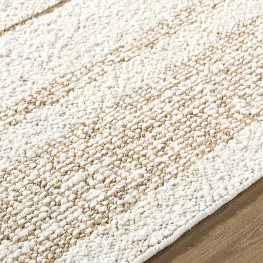 Close-up of the hand woven Ciaran Area Rug. Ivory and sandstone wool with a subtle striped pattern. Texture