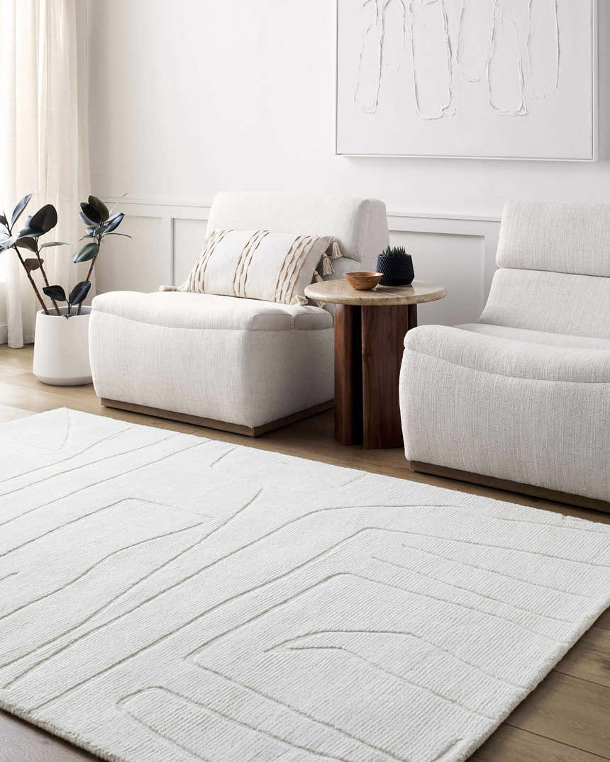 Living room scene with off-white Camryn Area Rug, two armchairs, side table, and minimalist art. Roomscene-Rectangle