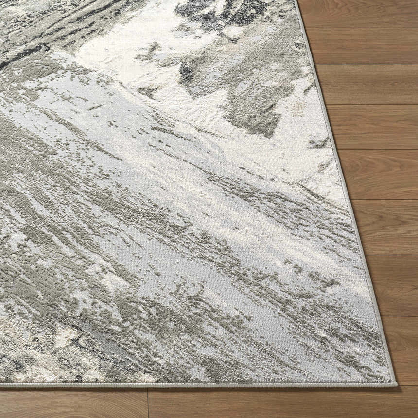 Close-up of the Chaeli Area Rug showing its beige, black, charcoal, and ivory contemporary pattern and machine woven texture. Front