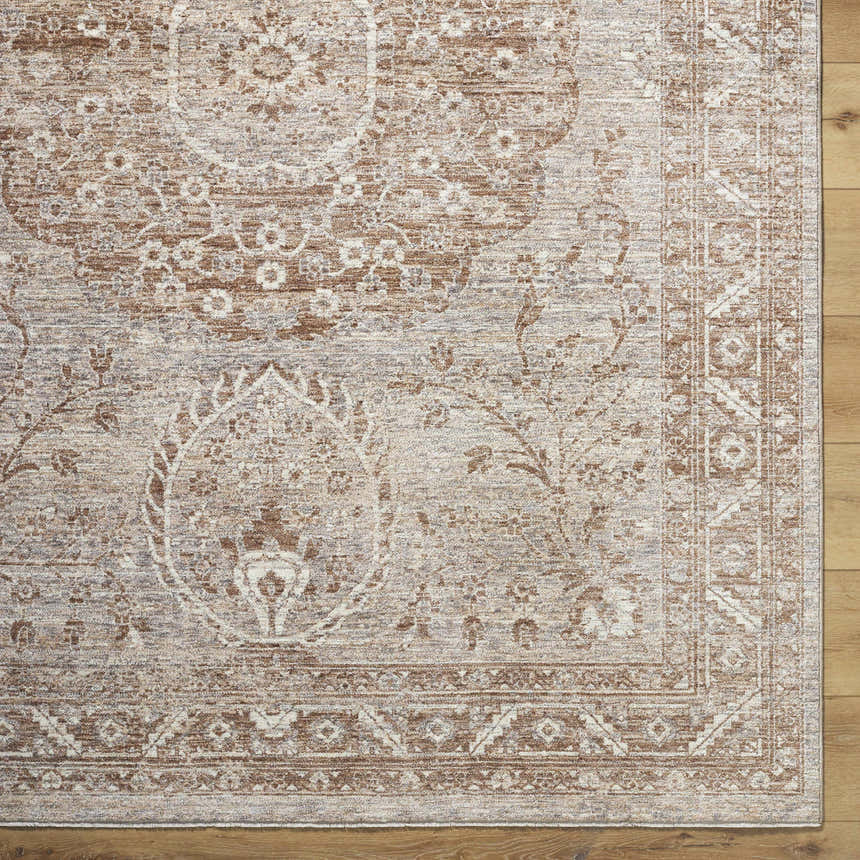 Close-up of Cosimo Area Rug. Farmhouse style rug in cream, dark red, gray, and tan with traditional floral pattern. Corner