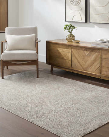 Living room scene with Cariel Light Sage Area Rug, wood cabinet, armchair and neutral decor. Roomscene-Rectangle