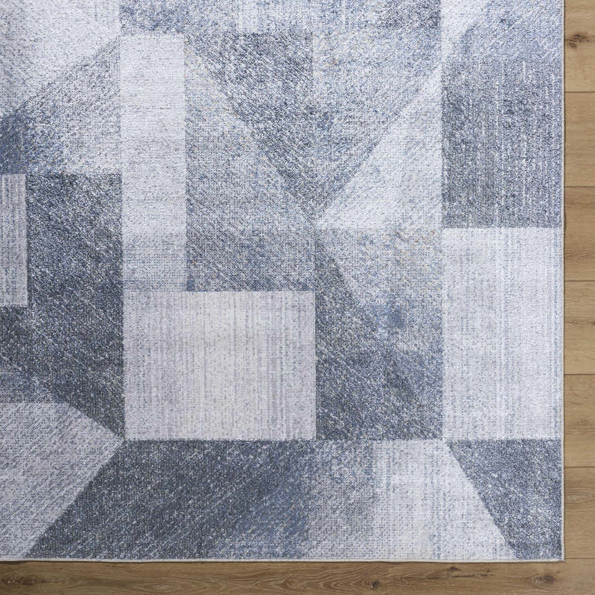 Close-up of the gray and blue Chachi Washable Geometric Rug showing the contemporary pattern and soft texture. Swatch