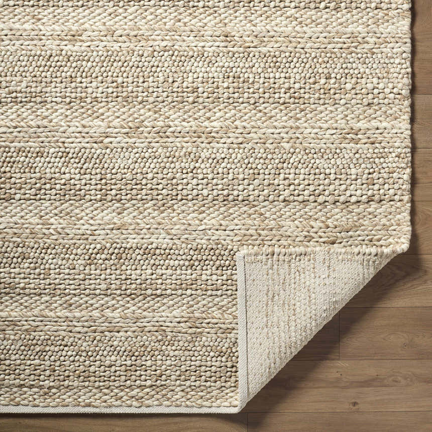 Close-up of the Ctadqe Beige Stripe Hand Woven Wool Area Rug showing texture and stripe detail. Medium brown wool on wood floor. Fold