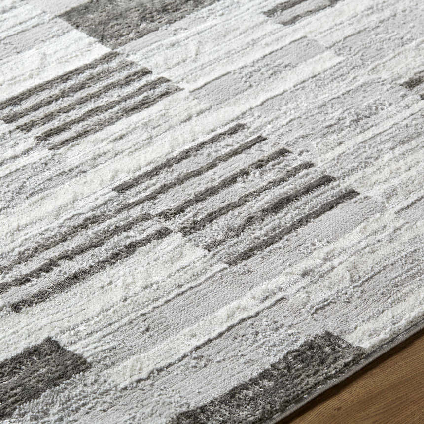 Close-up of the Chiaki Light Gray Area Rug, showing its ivory, light gray, and silver gray geometric pattern. Texture