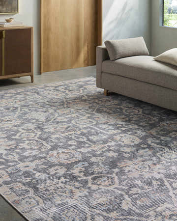 Living room scene with a Cheick Washable Area Rug, navy, off white, and orange traditional pattern, under a gray chaise lounge. Roomscene-Rectangle