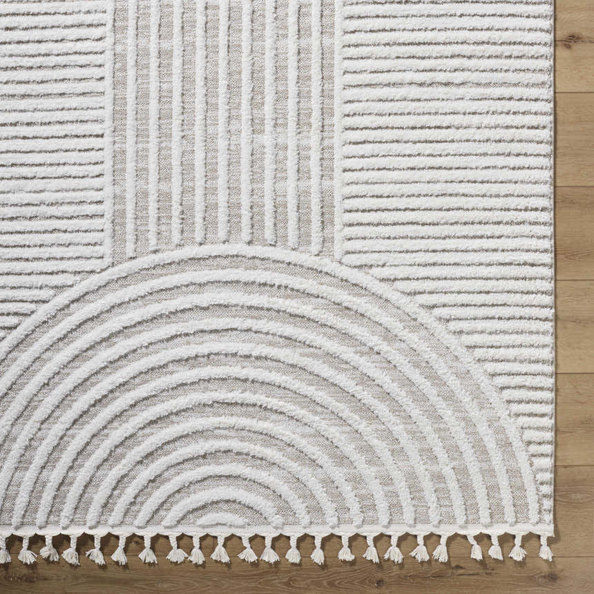 Close-up of the Cassie Area Rug; cream and peach rug with a geometric pattern. Corner