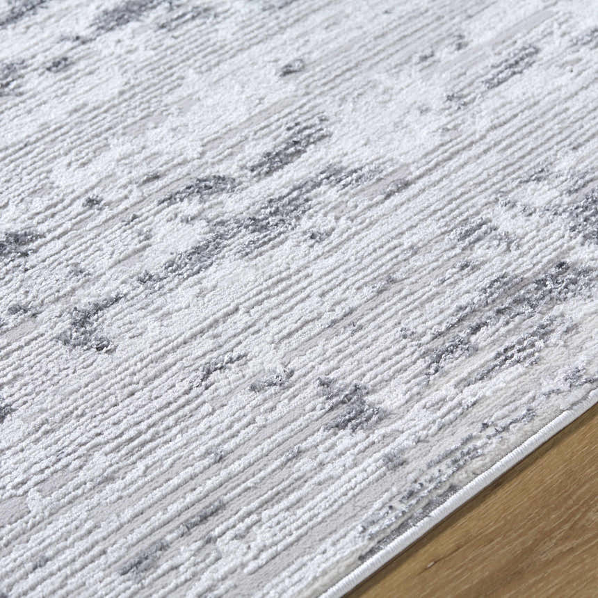 Close up of the Candie Gray Area Rug showing its cream, ivory, and light gray contemporary design. Texture