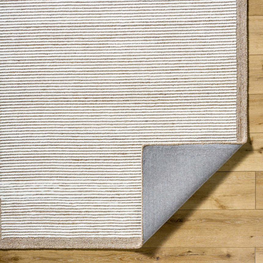 Close-up of the hand-tufted Cianna Area Rug. Beige, ivory, and tan stripes. 100% wool rug with a neutral backing. Fold