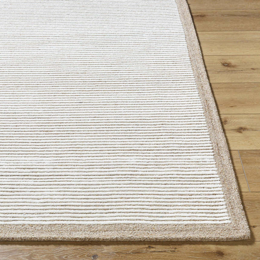 Close up of the Cianna Area Rug showing beige and ivory stripes and a tan border on hardwood floors. Front