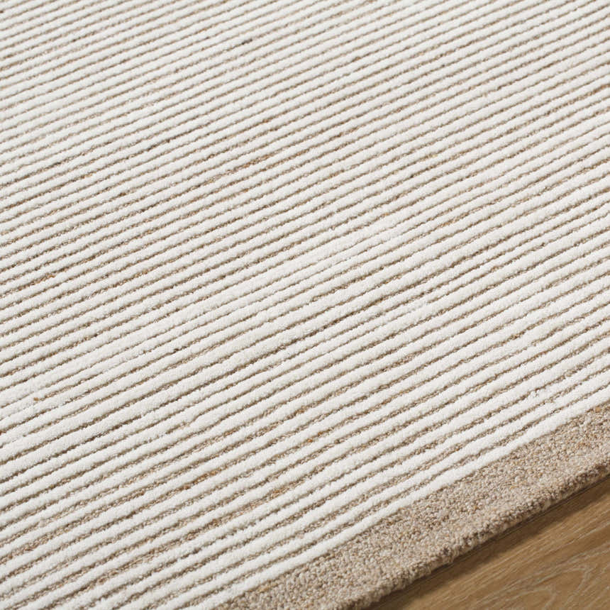 Close-up of the hand-tufted Cianna Area Rug. Beige and ivory wool stripes create a textured, transitional design. Texture