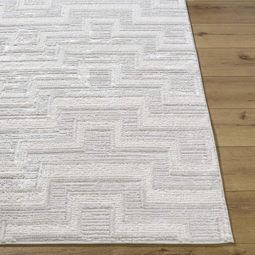 Close-up of the cream and ivory Cormac Area Rug showing the contemporary geometric pattern and soft texture. Front