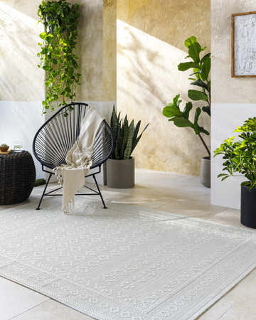 Serene bathroom scene with a light silver Ayunli Area Rug, modern chair, and lush green plants. Roomscene-Rectangle