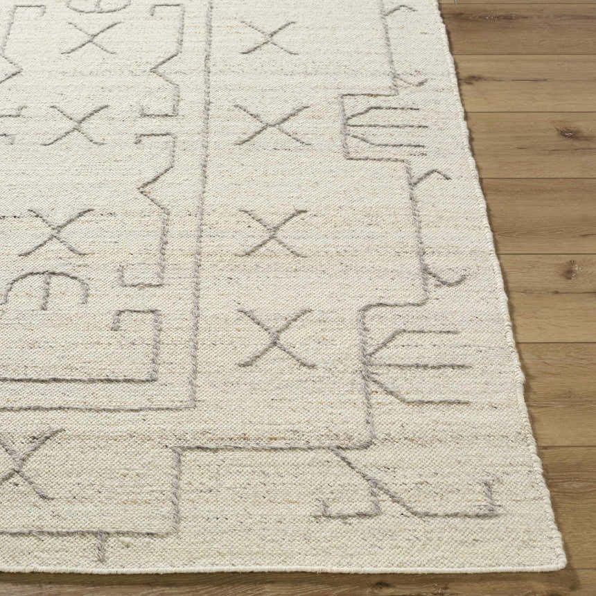 Close up of the hand woven Chanda Area Rug showing the beige wool texture and geometric design. Front
