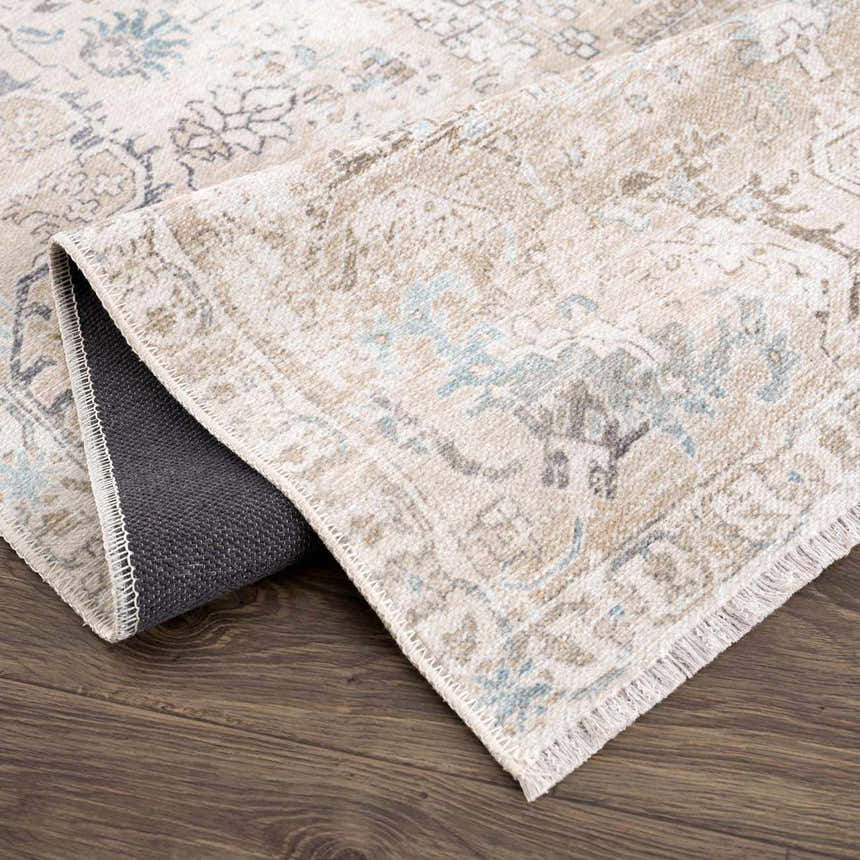 Close-up of the Beige Holi-4600 Washable Area Rug showing its cream, brown, and peach traditional vintage pattern and fringed edge. Fold