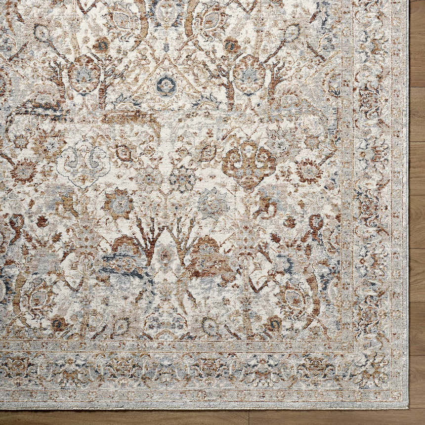 Close-up of the Chikao Cream Area Rug. Beige, cream, mustard, and blue traditional floral pattern on a soft polyester rug. Corner