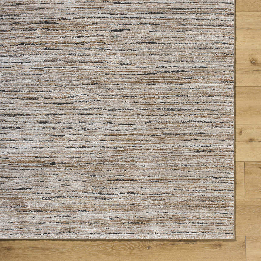 Close-up of a Wantu Luxe Thick Area Rug showing ivory, tan, and black horizontal striations on a wood floor. Corner