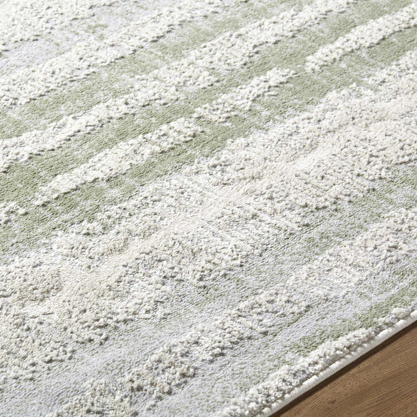 Close up of the Asmara Green Area Rug showing its sage, light silver, and white textured stripe pattern. Texture