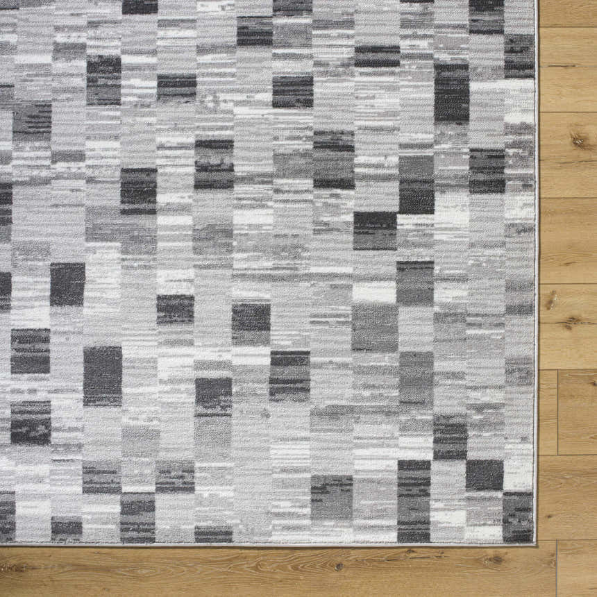 Close-up of the Alagan Medium Gray Area Rug showing its contemporary block pattern and light silver, sage, and gray colors. Swatch