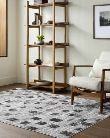 Living room scene with a light wood bookshelf and chair on an Alagan Medium Gray Area Rug. Roomscene-Rectangle