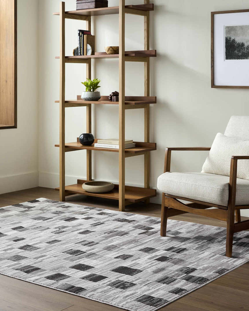 Living room scene with a light wood bookshelf and chair on an Alagan Medium Gray Area Rug. Roomscene-Rectangle
