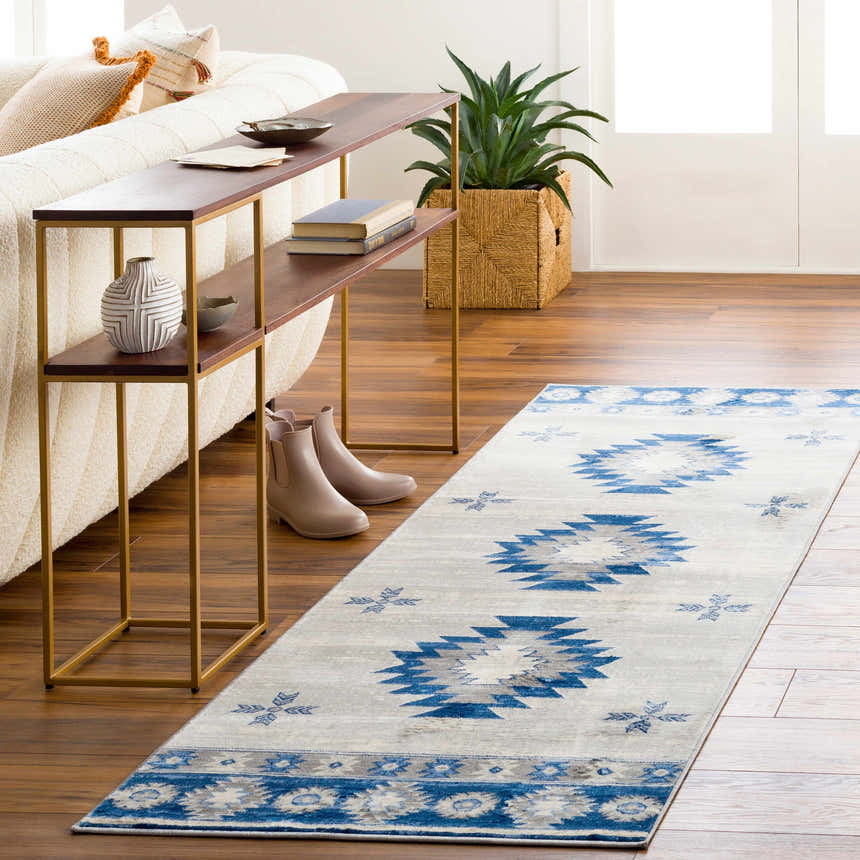 Living room scene with a denim and ivory Dumfries Area Rug runner and a modern console table. Roomscene-Runner
