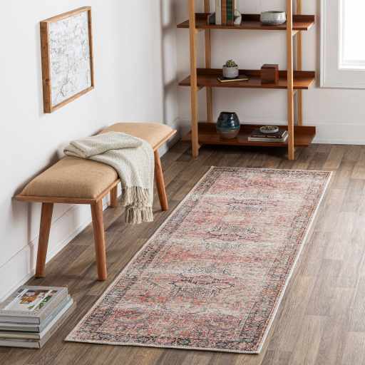 Entryway scene with a pink and blue Dunsha Boutique Washable Area Rug, bench, and wood shelving. Roomscene-Runner