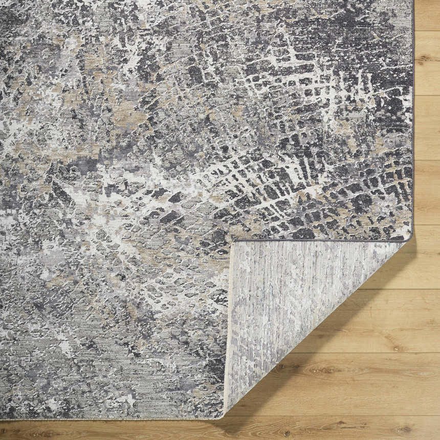Close-up of the Aolani Medium Gray Area Rug showing its black, gray, ivory, and tan Southwestern pattern and texture. Fold
