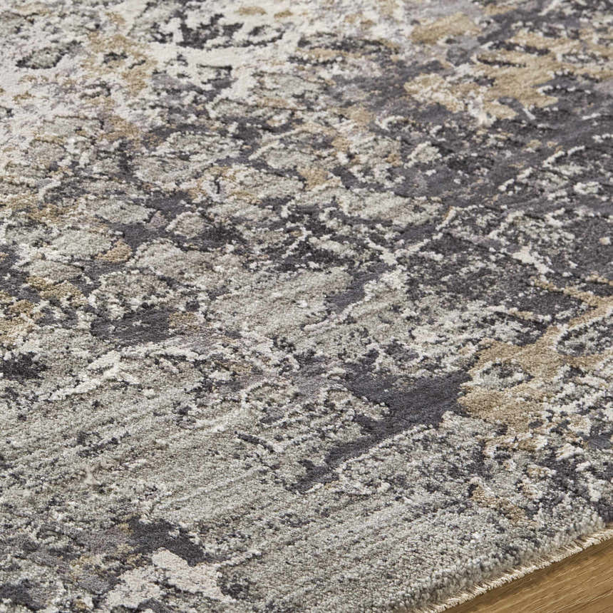 Close up of the Aolani Medium Gray Area Rug, featuring a Southwestern-inspired pattern in gray, ivory, black and tan. Texture