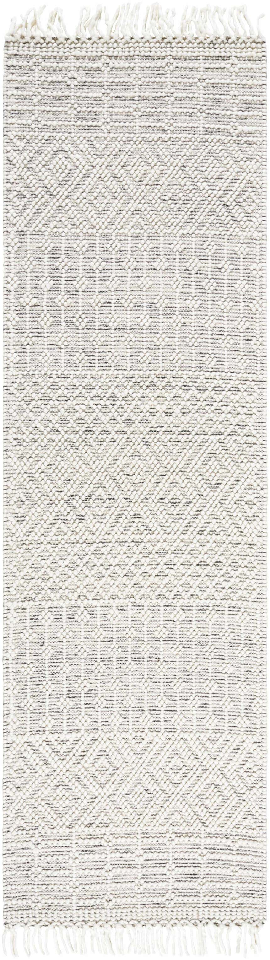 Close-up of the hand woven Egil Wool-blend Area Rug with a geometric pattern and off white fringe. Design-Runner-268