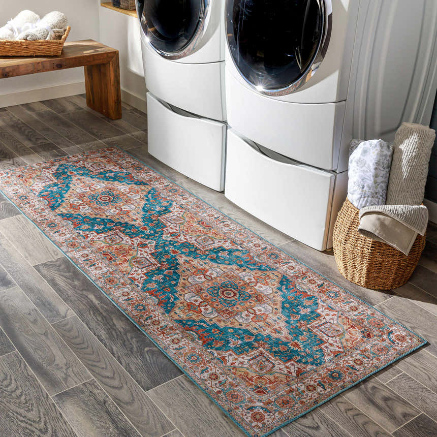 Laundry room scene with Eglinton Area Carpet runner in burnt orange, blue, and red. Farmhouse style with washing machine and wood bench. Roomscene-Runner
