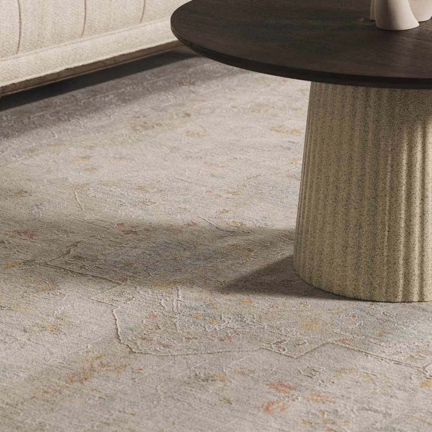 Close-up of Engin Thick Luxe Area Rug showing its traditional pattern, amber, pink, and gray colors, and plush texture. Styleshot