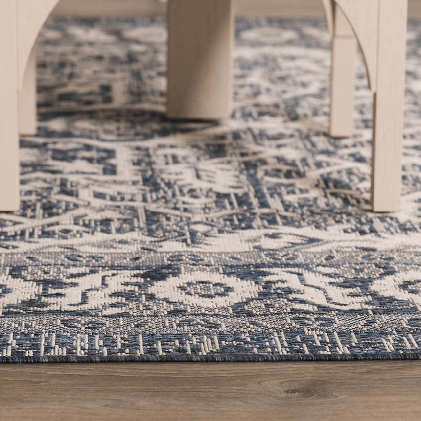 Close-up of the Etoile Navy Blue Performance Rug showing its traditional blue and white pattern and woven texture. Roomscene-Rectangle