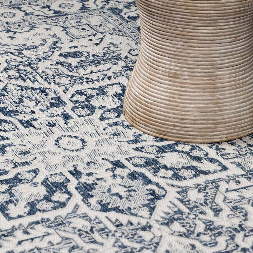 Close up of the Etoile Navy Blue Performance Rug showing its traditional blue and white pattern and texture. Styleshot