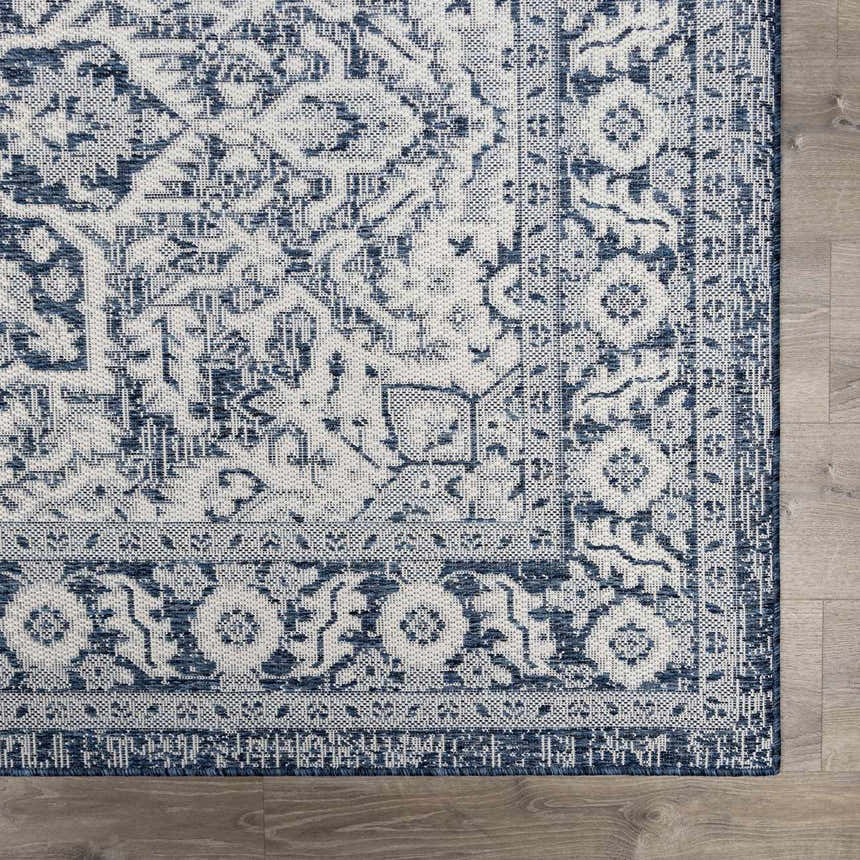 Close-up of the Etoile Navy Blue Performance Rug, showcasing its traditional, intricate blue and white pattern. Swatch