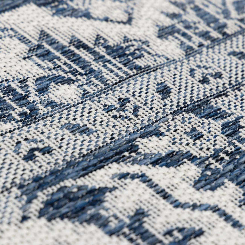 Close-up of the Etoile Navy Blue Performance Rug showing its woven texture and geometric pattern in blue and white. Texture