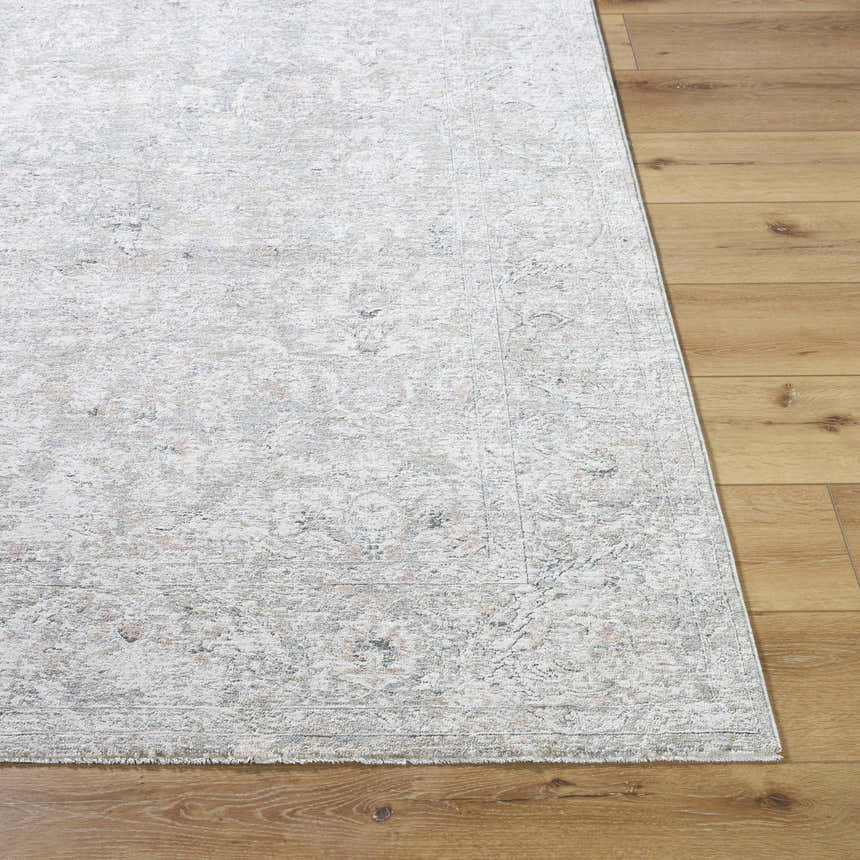 Close-up of the cream, light sage, and slate blue Azania Area Rug on a light wood floor. Farmhouse traditional style. Front