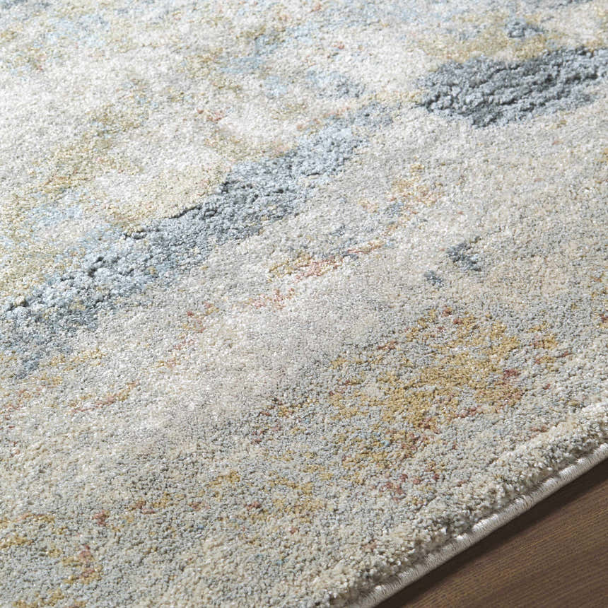 Close-up of the Alanna Thick Luxe Area Rug. Beige, gray, light gray, olive, pale blue, and teal hues create a contemporary design. Texture
